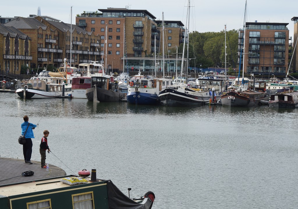 Father and son fishing off the side of Limehouse Basin